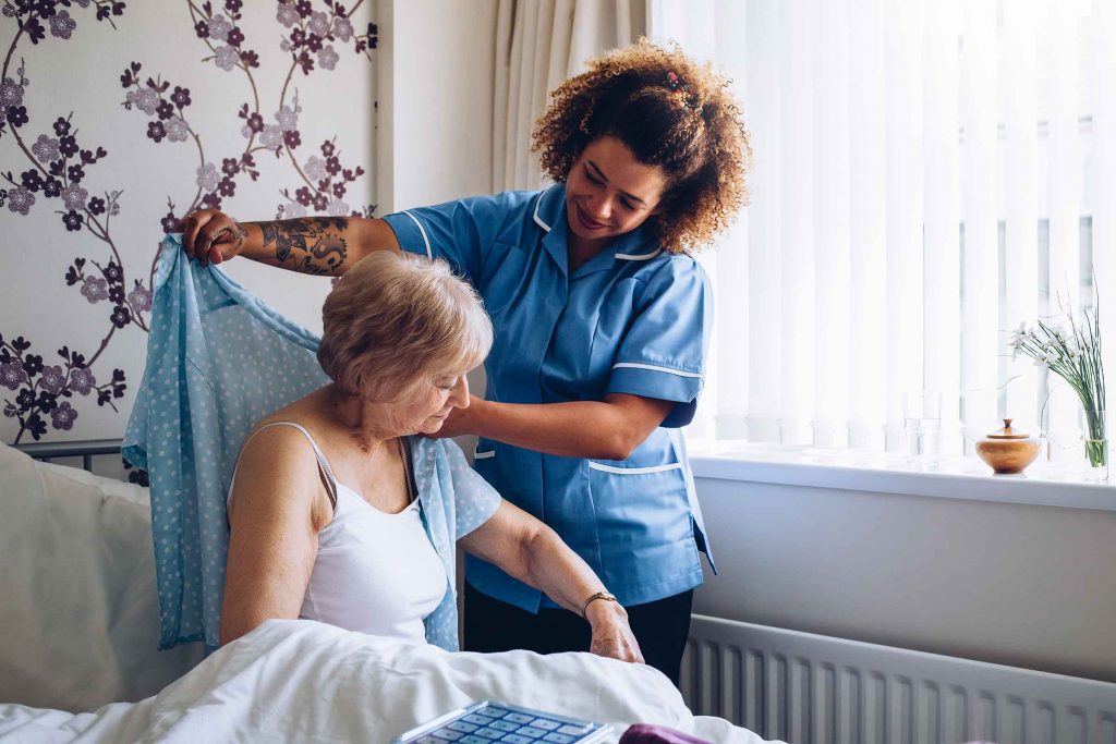 caregiver helping client get dressed